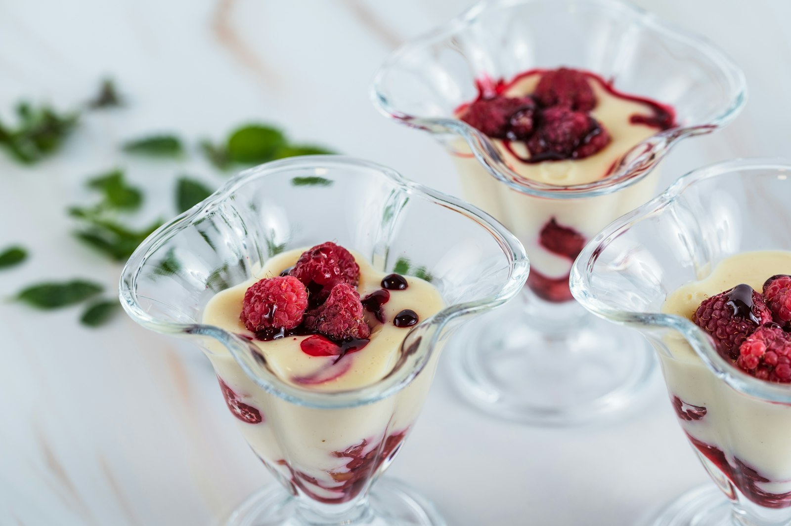 Layered cream and berries served in small glasses